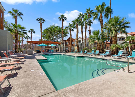 Community Swimming Pool with Pool Furniture at Stonegate Apartments in Las Vegs, NV.