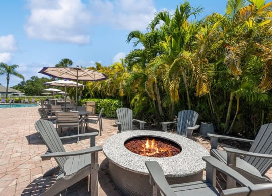 Community Fire Pit Area with Patio Furniture at Waverley Place Apartments in Naples, FL.