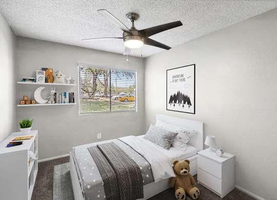Model Bedroom with Carpet and Window View at Solano Springs Apartments located in Tucson, AZ.