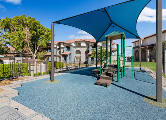 Community Playground with Blue Canopy at Stillwater Apartments in Glendale, AZ.