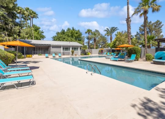 Community Swimming Pool with Pool Furniture at Lakeside Casitas Apartments in Tucson, AZ.
