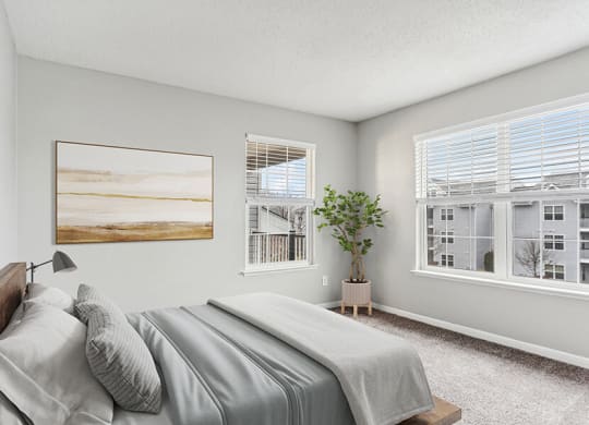 Model Bedroom with Carpet and Window Views at Commons at Haynes Farm Apartments in Shrewsbury, MA.