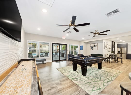Community Clubhouse with Game Tables at Retreat at Crosstown Apartments in Riverview, FL.