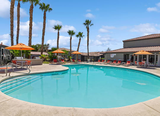 Community Swimming Pool with Pool Furniture at Loma Vista Apartments in Las Vegas, NV.