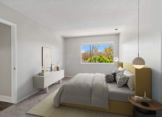 Model Bedroom with Carpet and Window View at Fullerton Hills Apartments located in Fullerton, CA.