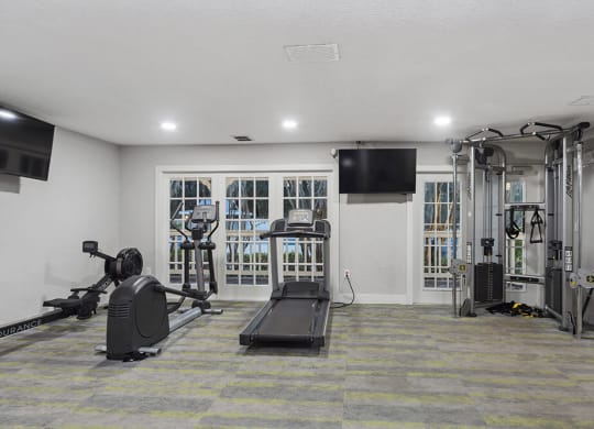 Community Fitness Center with Equipment at Walden Lake Apartments in Plant City, FL.