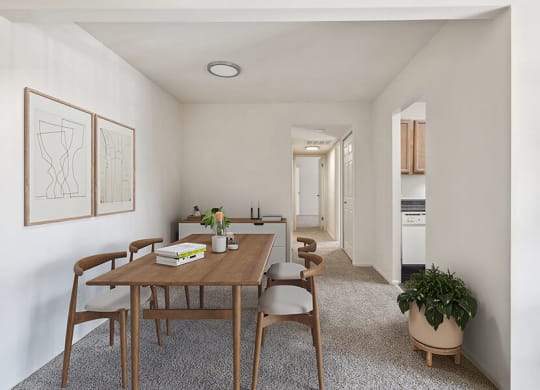 Model Dining Room with Carpet and View of Kitchen at Spring Parc Apartments in Silver Spring, MD.