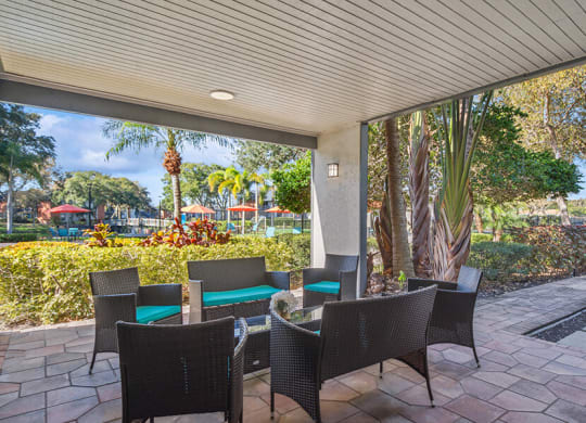 Outdoor Lounge Area with Covered Furniture at Bridges at Bayside Apartments in St. Petersburg, FL.