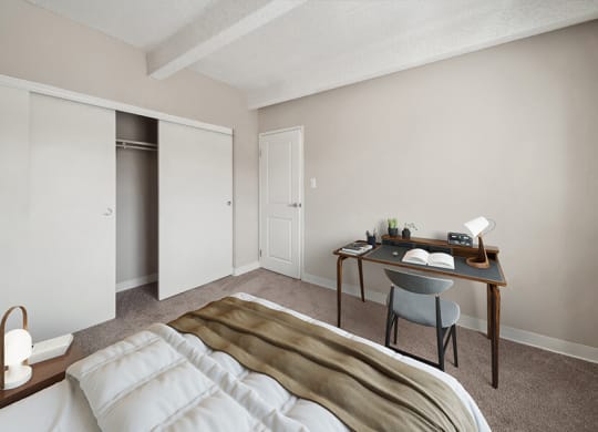 Model Bedroom with Carpet and Closet at Esprit at Cherry Creek Apartments in Glendale, CO.