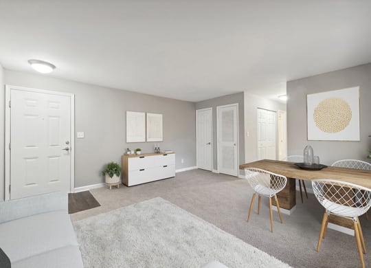 Model Living Room with Carpet and View of Dining Room at Spring Forest Apartments in Raleigh, NC.