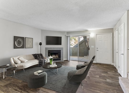 Model Living Room with Wood-Style Flooring and Patio Accessibility at Meadow Ridge Apartments in Las Vegas, NV.