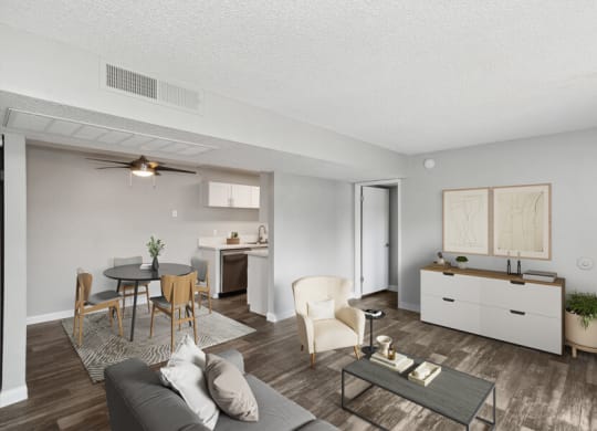 the living room and dining room of an apartment with a table and chairs