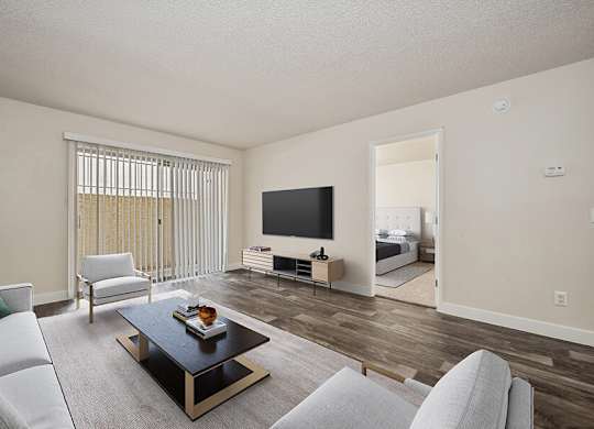 Model Living Room with Wood-Style Flooring and Patio Accessibility at Butler Ridge Apartments located in Glendale, AZ.