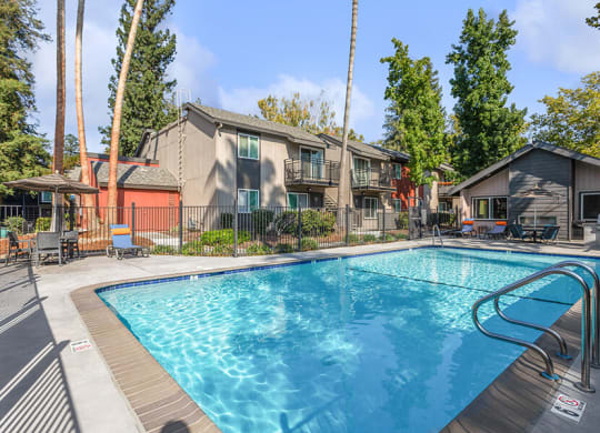 Community Swimming Pool with Pool Furniture at The Archer Apartments in Sacramento, CA.