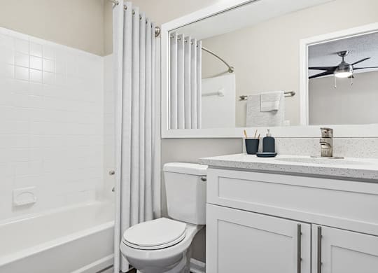 Model Bathroom with White Cabinets, Wood-Style Flooring and Shower/Tub at Element 41 Apartments located in Marietta, GA.