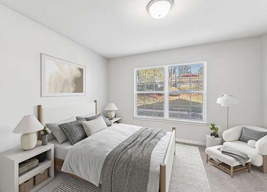 Model Bedroom with Carpet and Window View at Lake Cameron Apartments located in Apex, NC.
