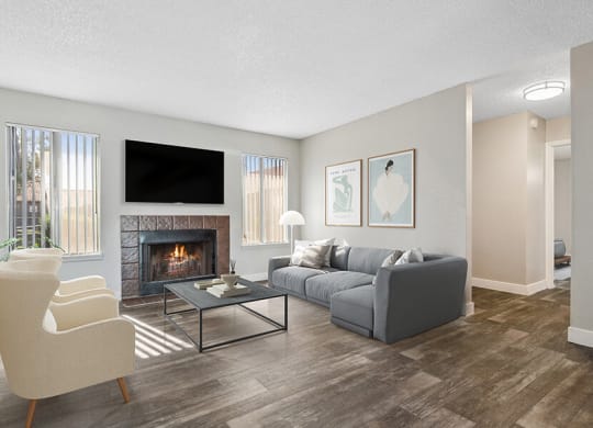 Model Living Room with Wood-Style Flooring and Fireplace at Peaks on 4th Apartments in Avondale, AZ.