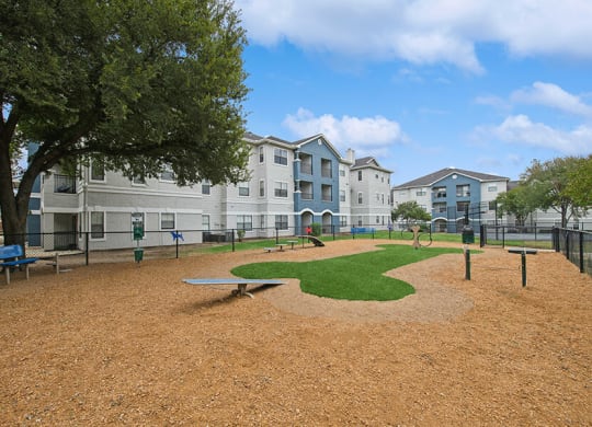 Community Dog Park with Agility Equipment at Hidden Creek Apartments located in Lewisville, TX.