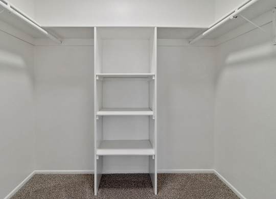 Model Closet with Carpet and Built In Shelves at Fullerton Hills Apartments located in Fullerton, CA.