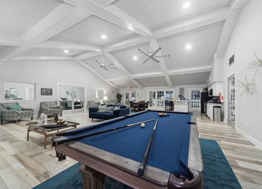 Community Clubhouse with Lounge Furniture and Pool Table Area at Walden Lake Apartments in Plant City, FL.