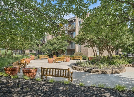 Community Courtyard with Benches and Flower Pots at Mason Van Dorn Apartments located in Alexandria, VA.