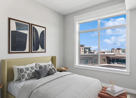 Model Bedroom with Carpet and Window View at Seven Skies Apartments located in Sandy, UT.