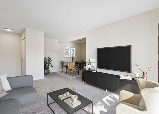 Model Living Room with Carpet and View of Dining Room at Spring Parc Apartments in Silver Spring, MD.