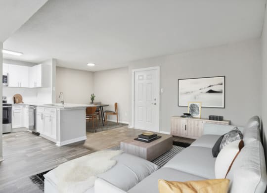 a living room with a couch and a kitchen