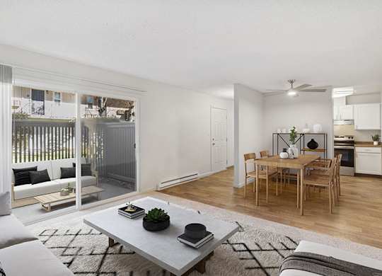 Model Living Room with Carpet, View of Dining Area, and Patio Accessibility at Los Gatos Landing Apartments located in San Jose, CA.