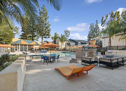 Community Swimming Pool with Pool Furniture at Horizon Apartments located in Santa Ana, CA.