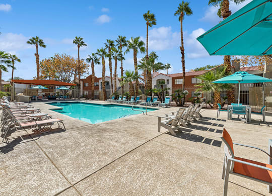 Community Swimming Pool with Pool Furniture at Stonegate Apartments located in Las Vegas, NV.