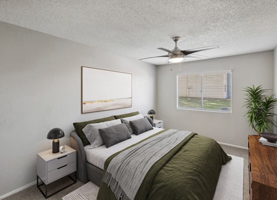 Model Bedroom with Carpet and Window View at Solano Springs Apartments located in Tucson, AZ.