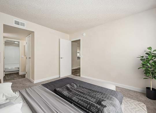 Model Bedroom with Carpet and attached Bathroom at Butler Ridge Apartments located in Glendale, AZ.