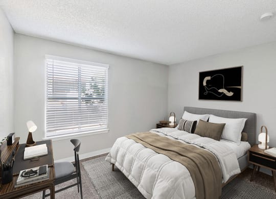 Model Bedroom with Carpet and Window View at Indigo Park Apartments located in Albuquerque, NM.