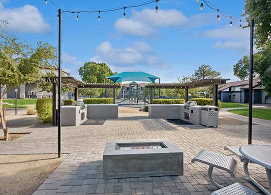Outdoor Fire Pit Area with Lounge Furniture at Stillwater Apartments located in Glendale, AZ.