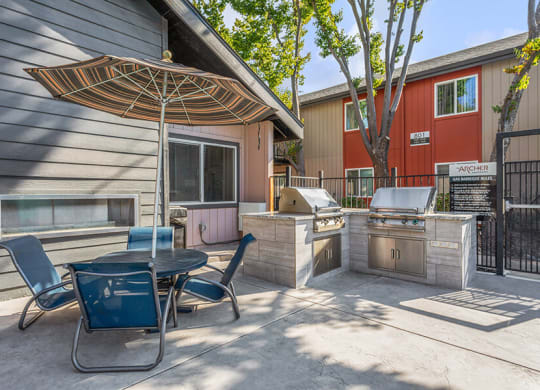 Outdoor BBQ Area with Furniture at The Archer Apartments in Sacramento, CA.