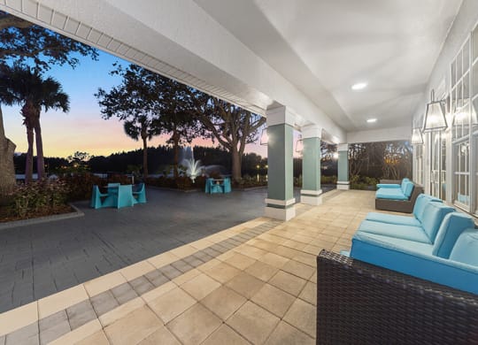 Community Patio Area with Lounge Furniture at Vinings at Hunter's Green Apartments in Tampa, FL.