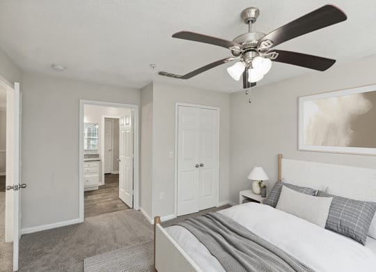 Model Bedroom with Carpet and attached Bathroom at Shadow Ridge Apartments in Riverdale, GA.