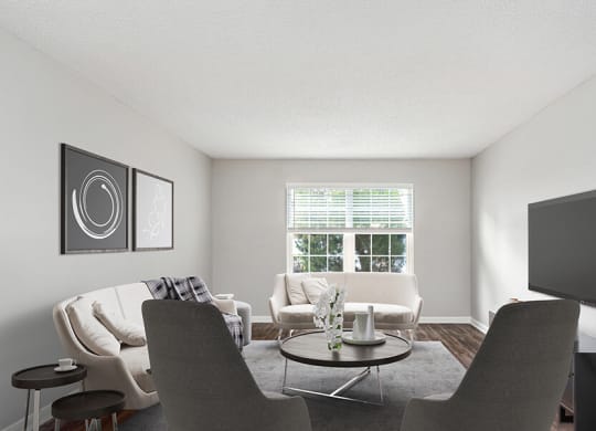 Model Living Room with Wood-Style Flooring and Window View at Commons at Haynes Farm Apartments in Shrewsbury, MA.