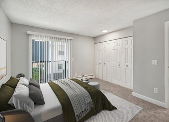 Model Bedroom with Carpet and Patio Accessibility at Waterfront Apartments in Lakewood, CO.