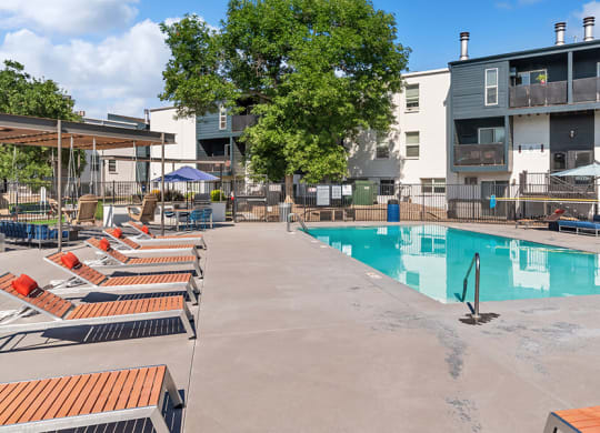 Community Swimming Pool with Pool Furniture at Waterfront Apartments in Lakewood, CO.