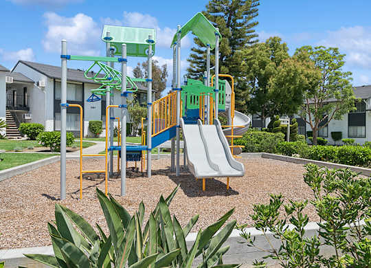Community Playground with Slides at Fullerton Hills Apartments located in Fullerton, CA.