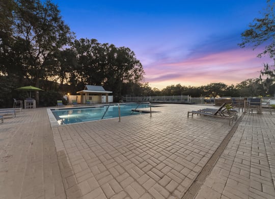 Community Swimming Pool with Pool Furniture at Walden Lake Apartments in Plant City, FL.