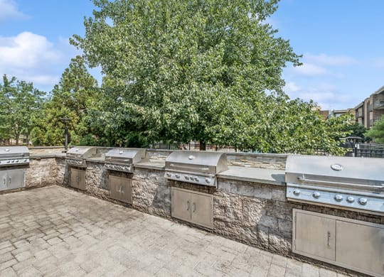Outdoor BBQ Area with Five Grills at Mason Van Dorn Apartments located in Alexandria, VA.