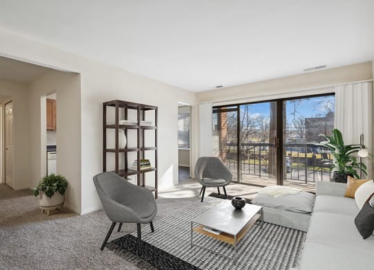 Model Living Room with Carpet and Patio Accessibility at Spring Parc Apartments in Silver Spring, MD.