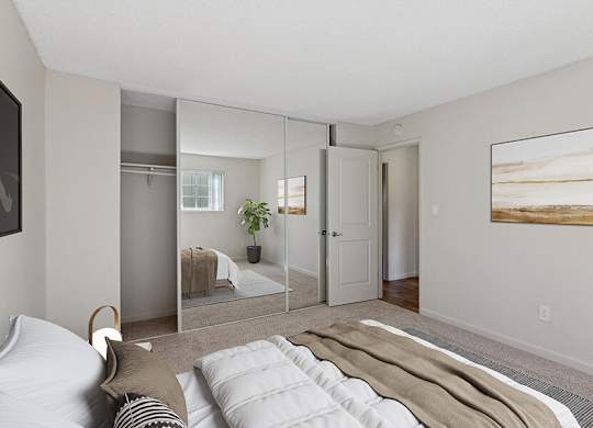 Model Bedroom with Carpet and Large Closet at Los Gatos Landing Apartments located in San Jose, CA.