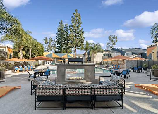 Community Swimming Pool with Pool Furniture at Horizon Apartments located in Santa Ana, CA.