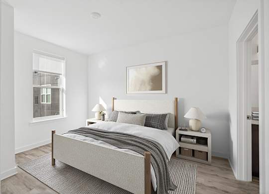Model Bedroom with Wood-Style Flooring  and attached Bathroom at Stella Apartments located in New Carrollton, MD.