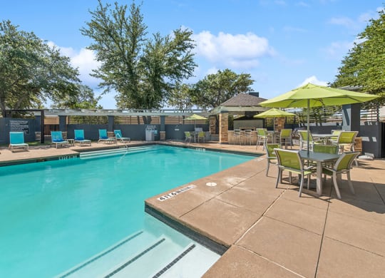 Community Swimming Pool with Pool Furniture at Allure North Dallas Apartments in Dallas, TX.