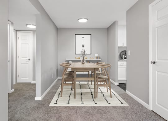 Model Dining Room with Carpet and View of Kitchen at Stone Ends Apartments in Stoughton, MA.